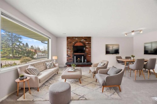 7720 Hunterquay Road Nw, Calgary, AB - Indoor Photo Showing Living Room With Fireplace