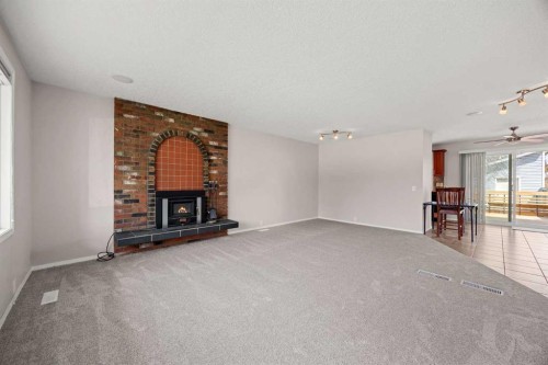 7720 Hunterquay Road Nw, Calgary, AB - Indoor With Fireplace