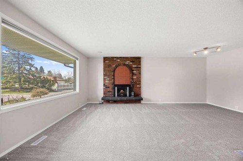 7720 Hunterquay Road Nw, Calgary, AB - Indoor With Fireplace