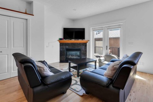 2-3421 5 Avenue Nw, Calgary, AB - Indoor Photo Showing Living Room With Fireplace