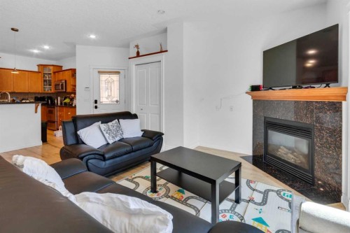 2-3421 5 Avenue Nw, Calgary, AB - Indoor Photo Showing Living Room With Fireplace