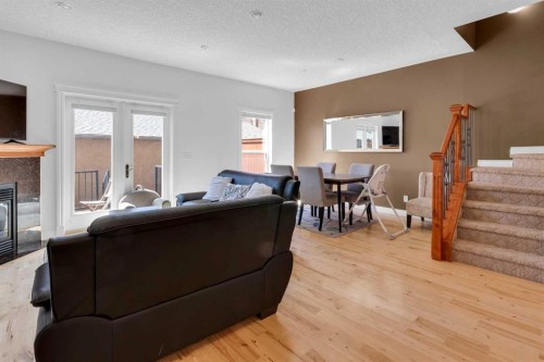 2-3421 5 Avenue Nw, Calgary, AB - Indoor Photo Showing Living Room With Fireplace