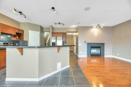 151 Everhollow Way Sw, Calgary, AB - Indoor Photo Showing Kitchen With Fireplace