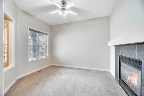 151 Everhollow Way Sw, Calgary, AB - Indoor Photo Showing Other Room With Fireplace