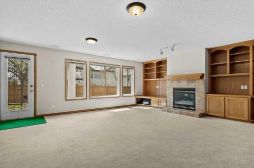 122 Rocky Ridge Villas Nw, Calgary, AB - Indoor Photo Showing Other Room With Fireplace