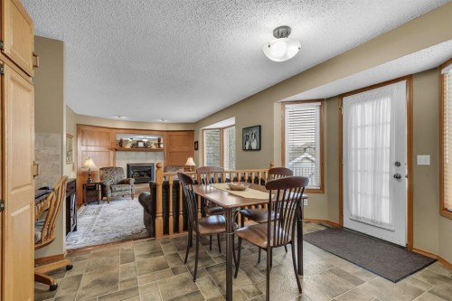 26 Tiller Place Se, Airdrie, AB - Indoor Photo Showing Dining Room With Fireplace