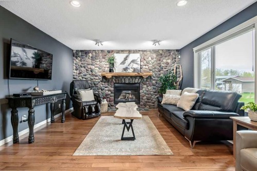 1105 Turner Gate Sw, Diamond Valley, AB - Indoor Photo Showing Living Room With Fireplace