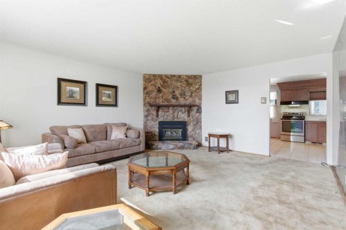 6215 Thorncliffe Drive Nw, Calgary, AB - Indoor Photo Showing Living Room With Fireplace