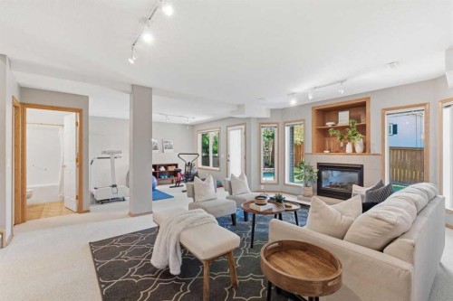 545 Rocky Ridge Bay Nw, Calgary, AB - Indoor Photo Showing Living Room With Fireplace