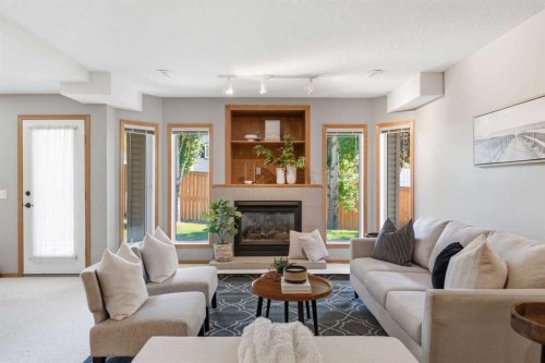 545 Rocky Ridge Bay Nw, Calgary, AB - Indoor Photo Showing Living Room With Fireplace