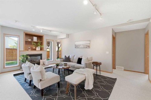 545 Rocky Ridge Bay Nw, Calgary, AB - Indoor Photo Showing Living Room With Fireplace