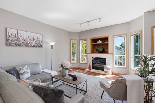 545 Rocky Ridge Bay Nw, Calgary, AB - Indoor Photo Showing Living Room With Fireplace