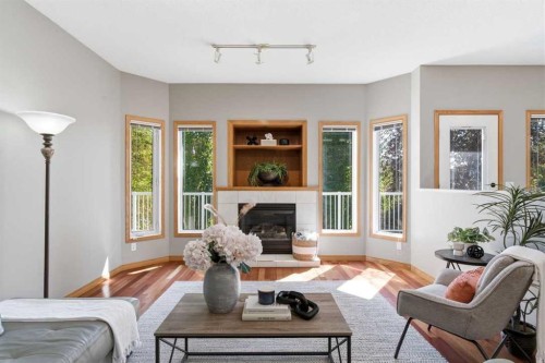 545 Rocky Ridge Bay Nw, Calgary, AB - Indoor Photo Showing Living Room With Fireplace