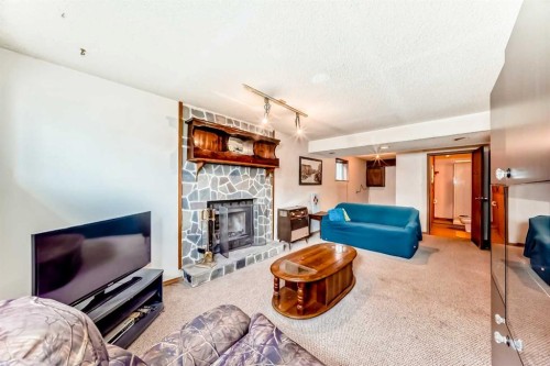 43 Mckenna Way Se, Calgary, AB - Indoor Photo Showing Living Room With Fireplace