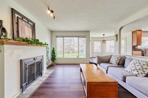 243 Hampshire Close Nw, Calgary, AB - Indoor Photo Showing Living Room With Fireplace