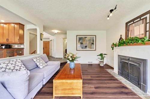 243 Hampshire Close Nw, Calgary, AB - Indoor Photo Showing Living Room With Fireplace