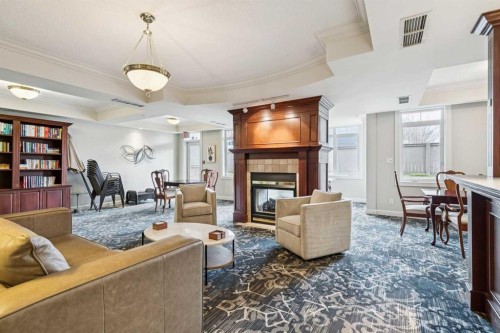 314-910 70 Avenue Sw, Calgary, AB - Indoor Photo Showing Living Room With Fireplace