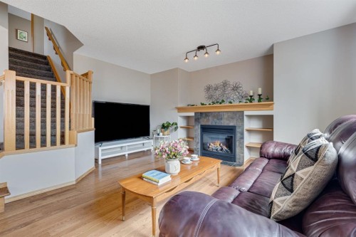 281 Bridlemeadows Common Sw, Calgary, AB - Indoor Photo Showing Living Room With Fireplace