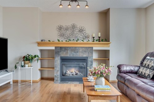 281 Bridlemeadows Common Sw, Calgary, AB - Indoor Photo Showing Living Room With Fireplace