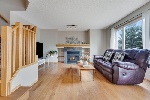 281 Bridlemeadows Common Sw, Calgary, AB - Indoor Photo Showing Living Room With Fireplace