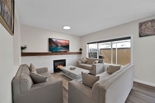 2386 Fairways Circle Nw, Airdrie, AB - Indoor Photo Showing Living Room With Fireplace