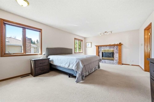 6 Christie Briar Lane Sw, Calgary, AB - Indoor Photo Showing Bedroom With Fireplace
