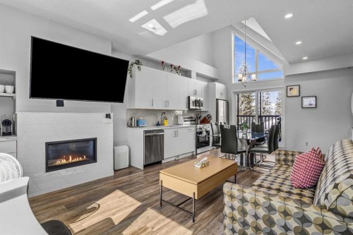 205-105 Kananaskis Way, Canmore, AB - Indoor Photo Showing Living Room With Fireplace