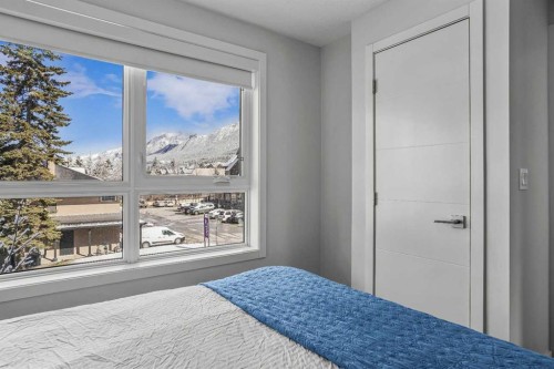 205-105 Kananaskis Way, Canmore, AB - Indoor Photo Showing Bedroom