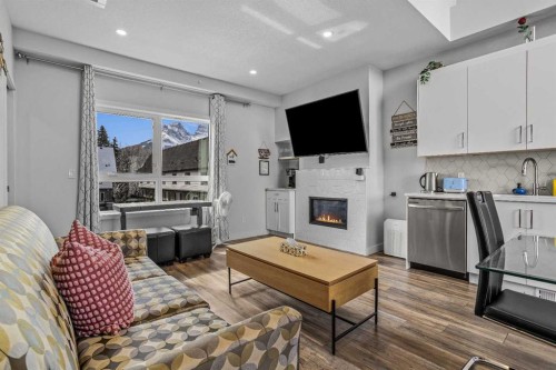 205-105 Kananaskis Way, Canmore, AB - Indoor Photo Showing Living Room With Fireplace