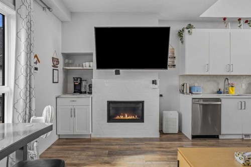 205-105 Kananaskis Way, Canmore, AB - Indoor Photo Showing Living Room With Fireplace