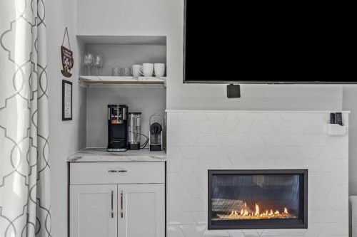 205-105 Kananaskis Way, Canmore, AB - Indoor Photo Showing Living Room With Fireplace