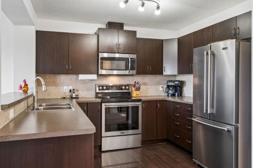 150 River Heights Crescent, Cochrane, AB - Indoor Photo Showing Kitchen With Double Sink With Upgraded Kitchen