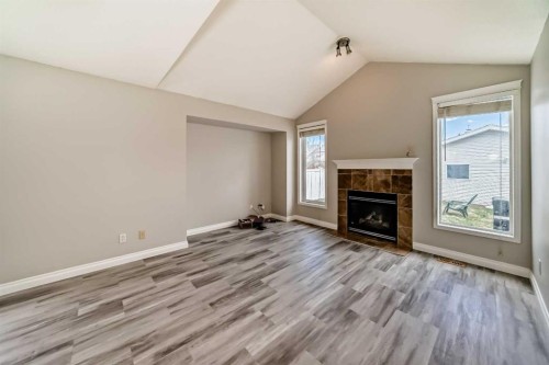 168 Tuscany Springs Way Nw, Calgary, AB - Indoor Photo Showing Living Room With Fireplace