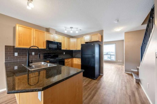 108 Sunrise Terrace Ne, High River, AB - Indoor Photo Showing Kitchen With Double Sink