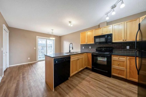 108 Sunrise Terrace Ne, High River, AB - Indoor Photo Showing Kitchen With Double Sink