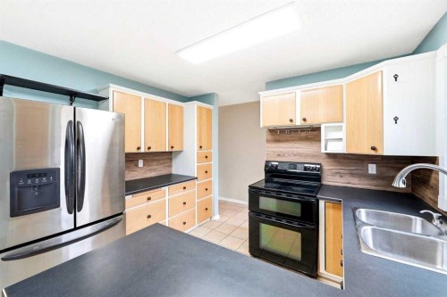 103 Thorson Crescent, Okotoks, AB - Indoor Photo Showing Kitchen With Double Sink