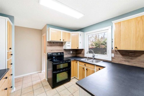 103 Thorson Crescent, Okotoks, AB - Indoor Photo Showing Kitchen With Double Sink