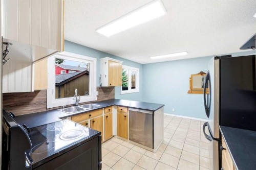 103 Thorson Crescent, Okotoks, AB - Indoor Photo Showing Kitchen With Double Sink
