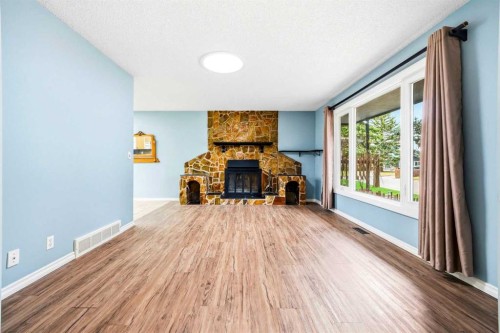 103 Thorson Crescent, Okotoks, AB - Indoor Photo Showing Living Room With Fireplace