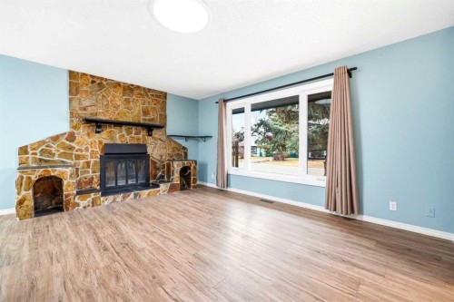 103 Thorson Crescent, Okotoks, AB - Indoor Photo Showing Living Room With Fireplace