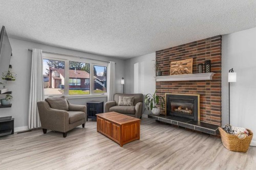 36 Bearberry Crescent Nw, Calgary, AB - Indoor Photo Showing Living Room With Fireplace
