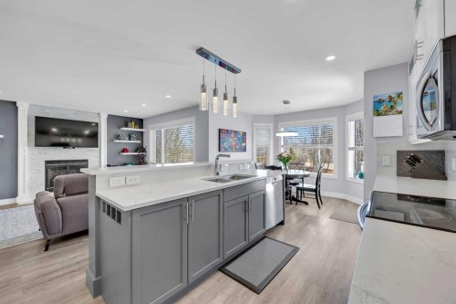 147 Hawkmere View, Chestermere, AB - Indoor Photo Showing Kitchen With Fireplace With Double Sink