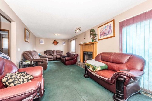 27 Ventura Way Ne, Calgary, AB - Indoor Photo Showing Living Room With Fireplace
