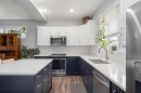 39 Heritage Boulevard, Cochrane, AB  - Indoor Photo Showing Kitchen With Stainless Steel Kitchen With Double Sink With Upgraded Kitchen 