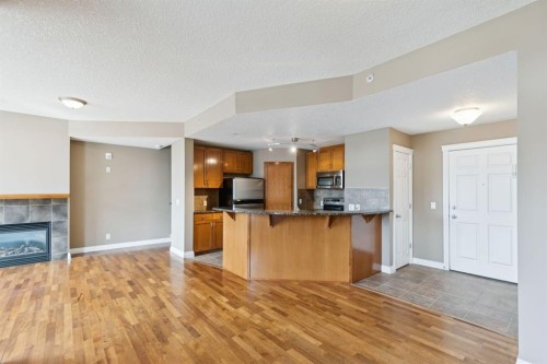 108-990 Centre Avenue Ne, Calgary, AB - Indoor Photo Showing Kitchen With Fireplace