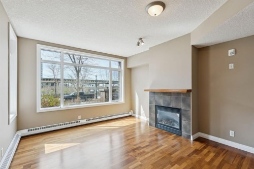 108-990 Centre Avenue Ne, Calgary, AB - Indoor Photo Showing Living Room With Fireplace