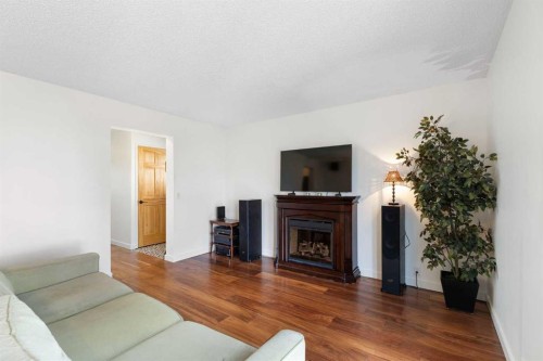 84 Abingdon Crescent Ne, Calgary, AB - Indoor Photo Showing Living Room With Fireplace