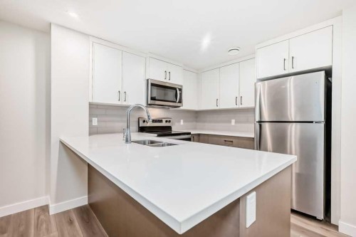 55 Silver Spruce Grove Sw, Calgary, AB - Indoor Photo Showing Kitchen With Double Sink With Upgraded Kitchen