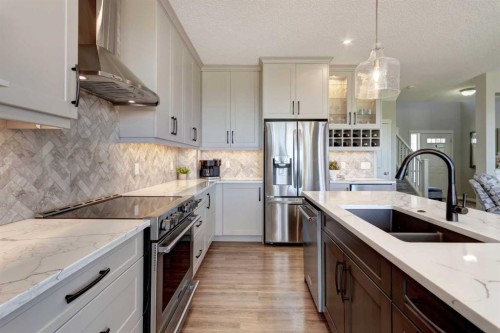 143 Cougarstone Court Sw, Calgary, AB - Indoor Photo Showing Kitchen With Double Sink With Upgraded Kitchen