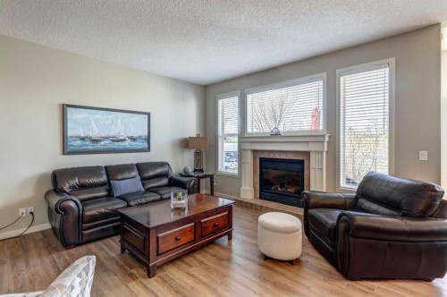 143 Cougarstone Court Sw, Calgary, AB - Indoor Photo Showing Living Room With Fireplace